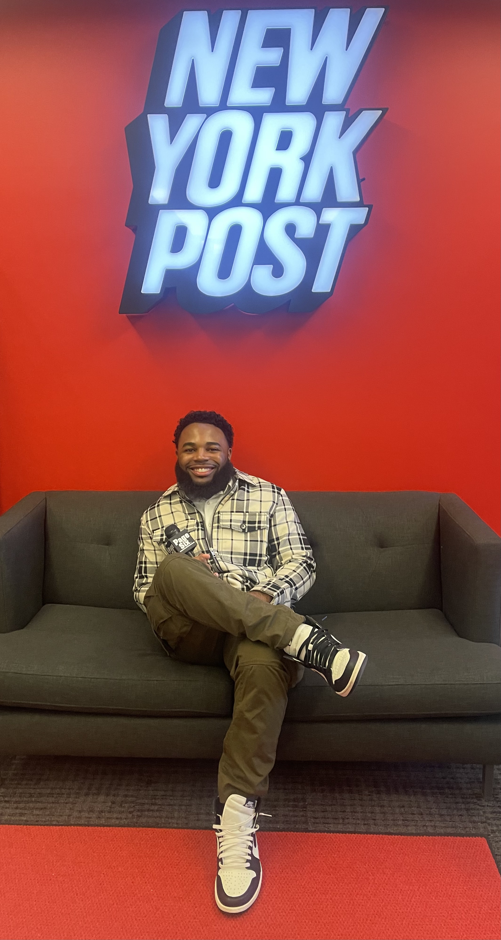Mekhi Carter at the New York Post holding a Page Six microphone